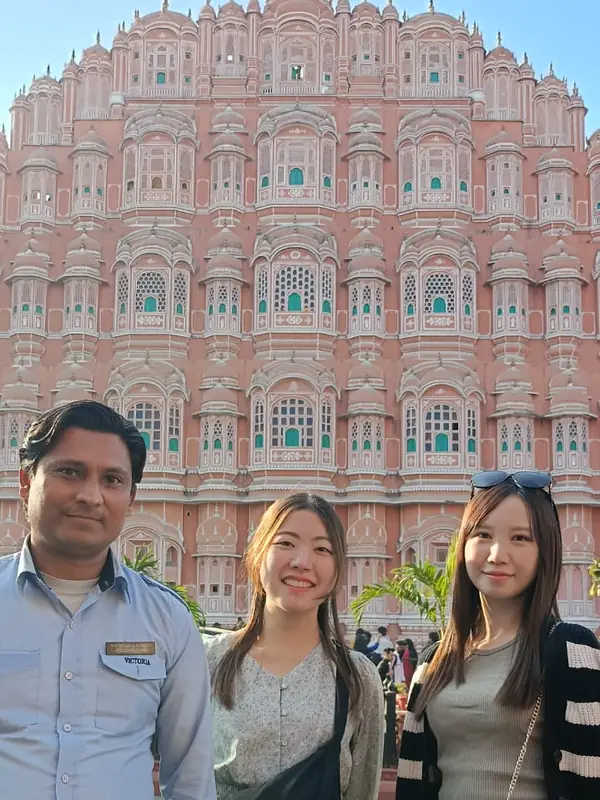 Two guests with their personal driver in front of Hawa Mahal, Jaipur